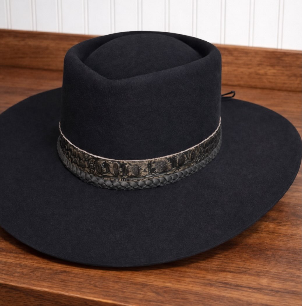 Black flat-brim hat showing smooth sanded felt surface