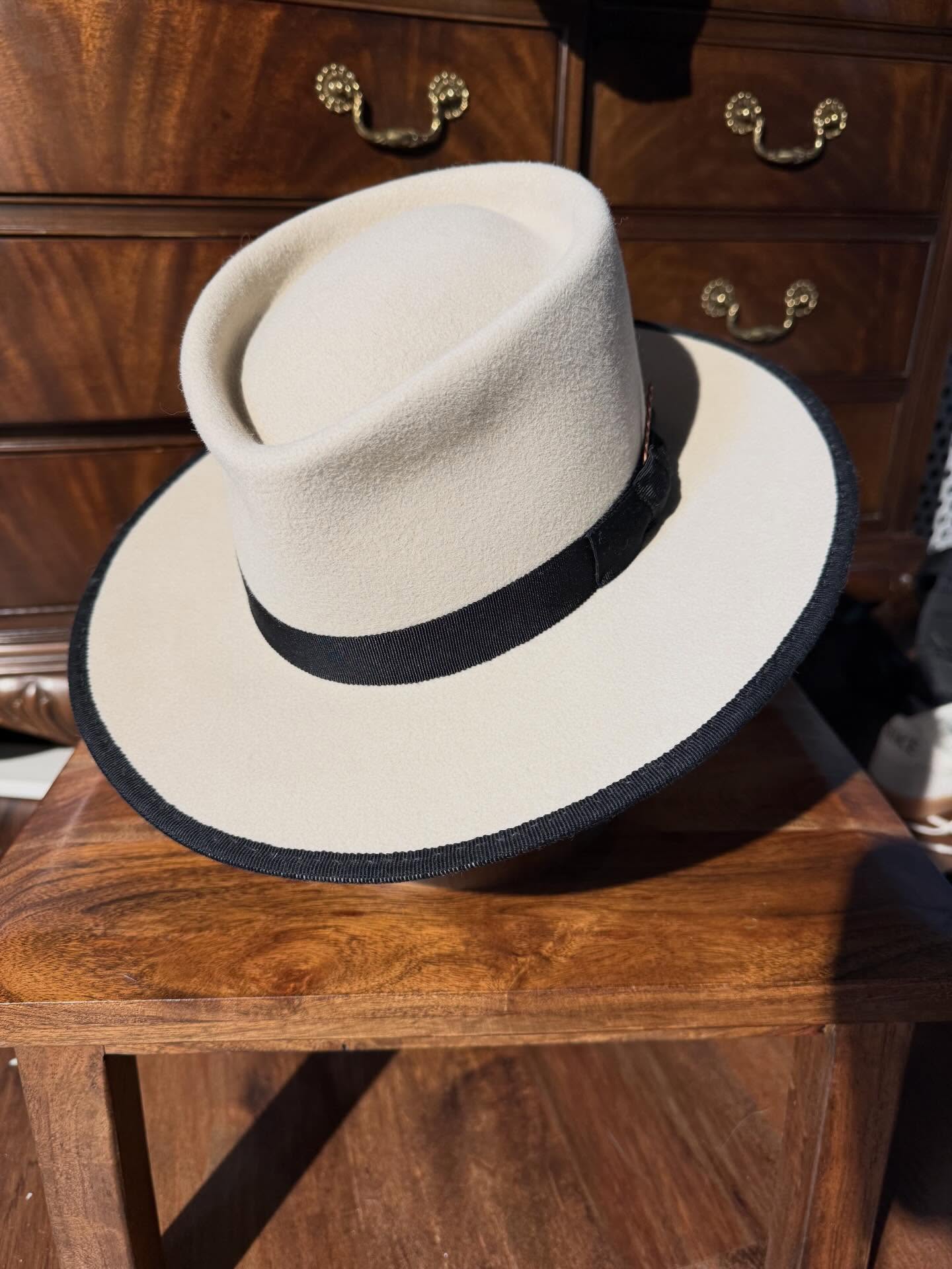 Ivory wide-brim hat showing the shaped brim profile