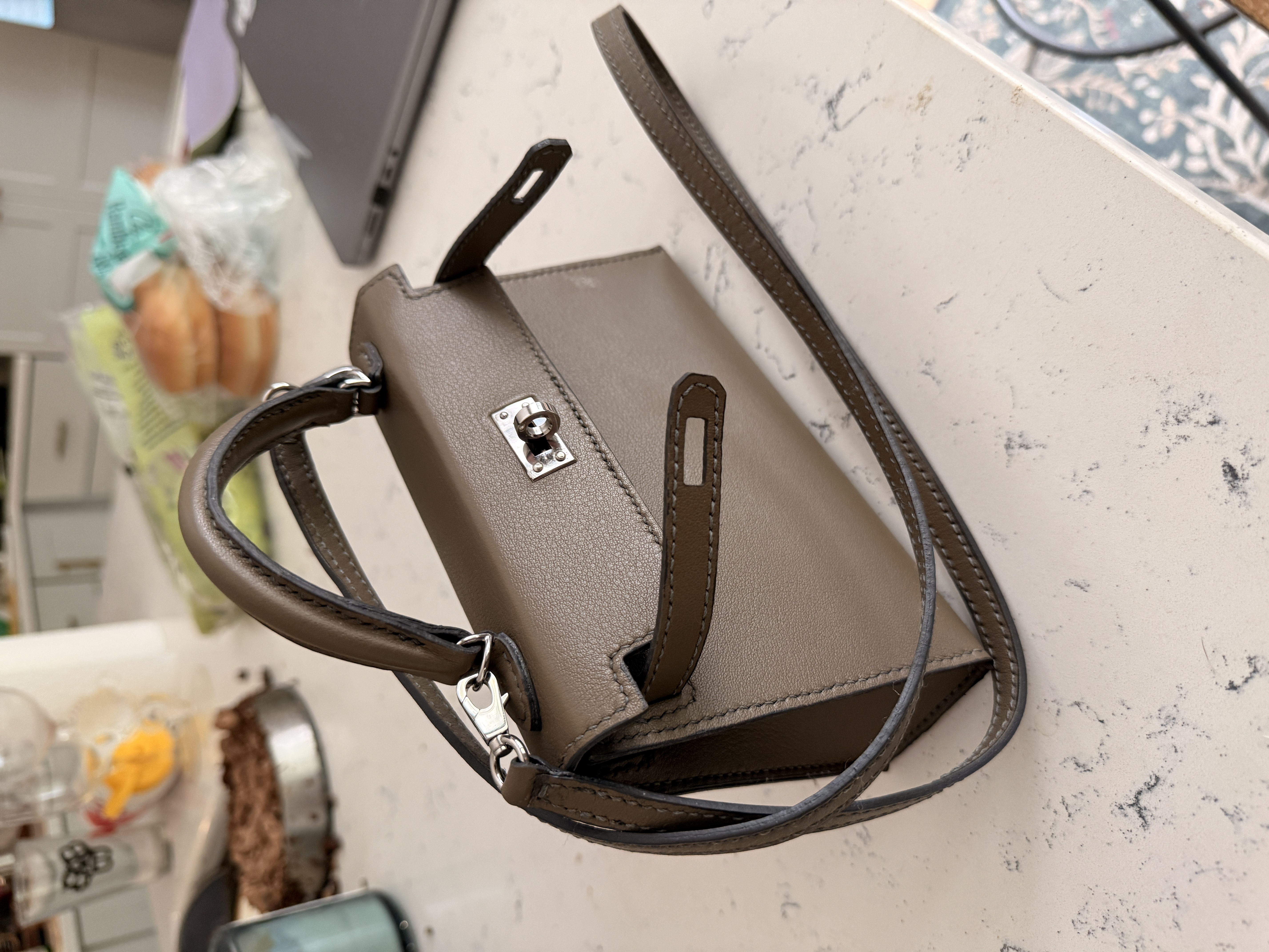 Taupe mini leather bag showing precision cut panels